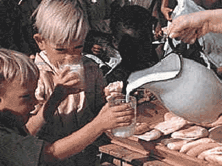 two boys enjoying glasses of milk